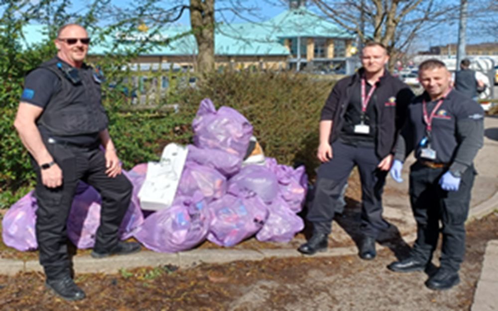 Officers next to trash