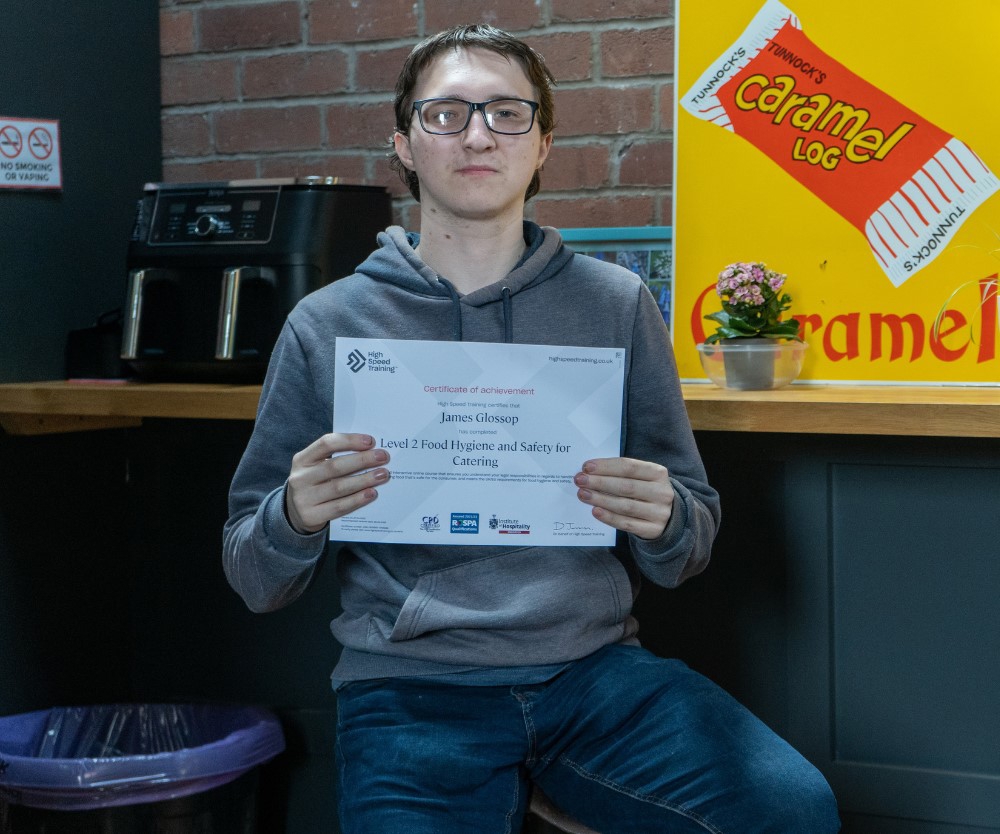 James holding certificate