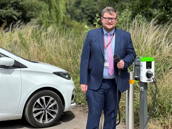 Cllr James Higginbottom and EV charger at Church Street Darton car park