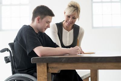 Young person in wheelchair with tutor