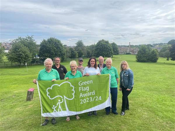 People holding Green Flag Award 2023/24 banner