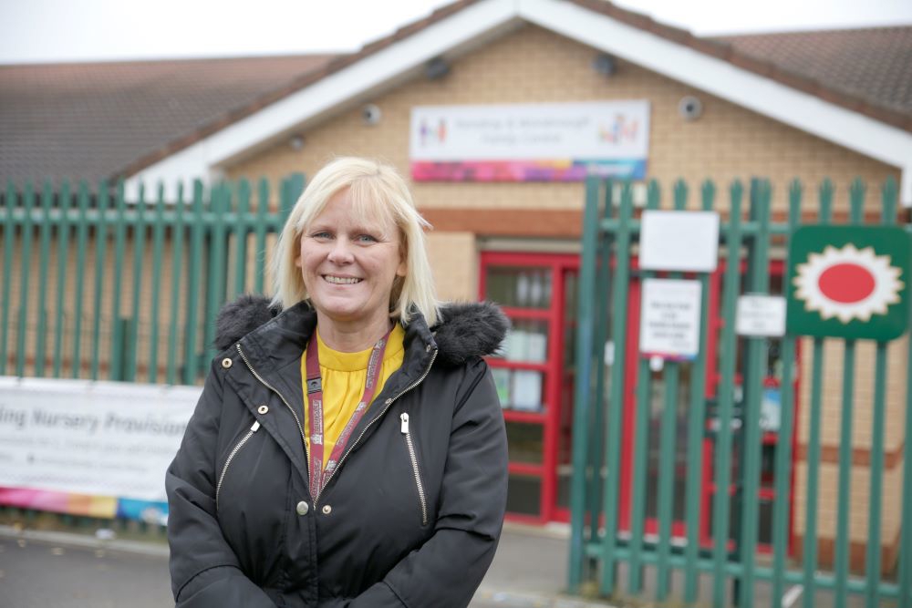 Woman stood outside school