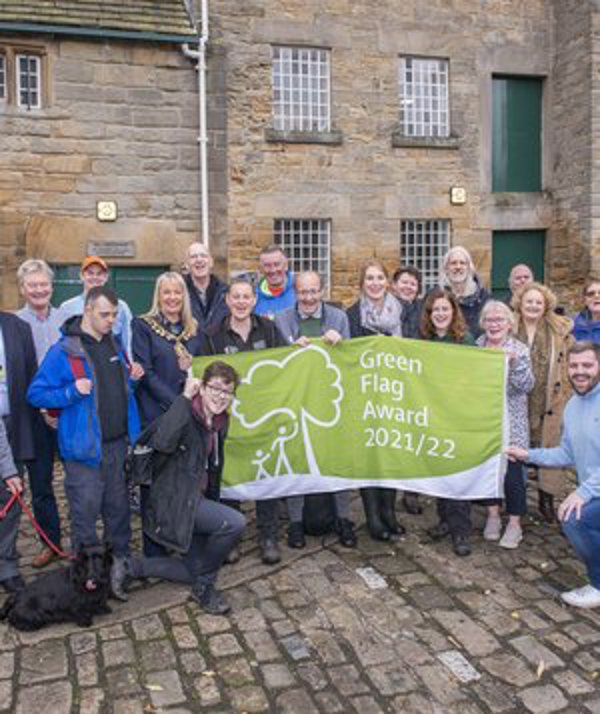 Volunteers with Green Flag Award 2021/22 banner