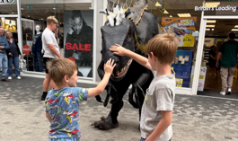 Children interacting with dinosaur.png