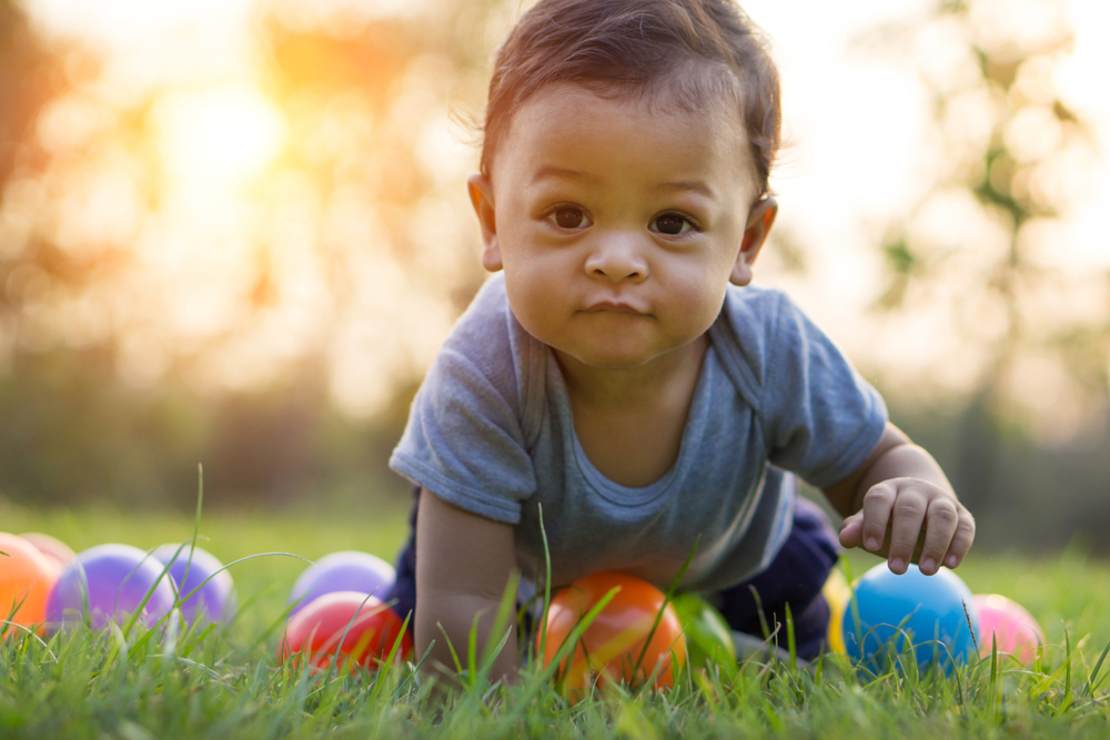 Baby crawling on grass