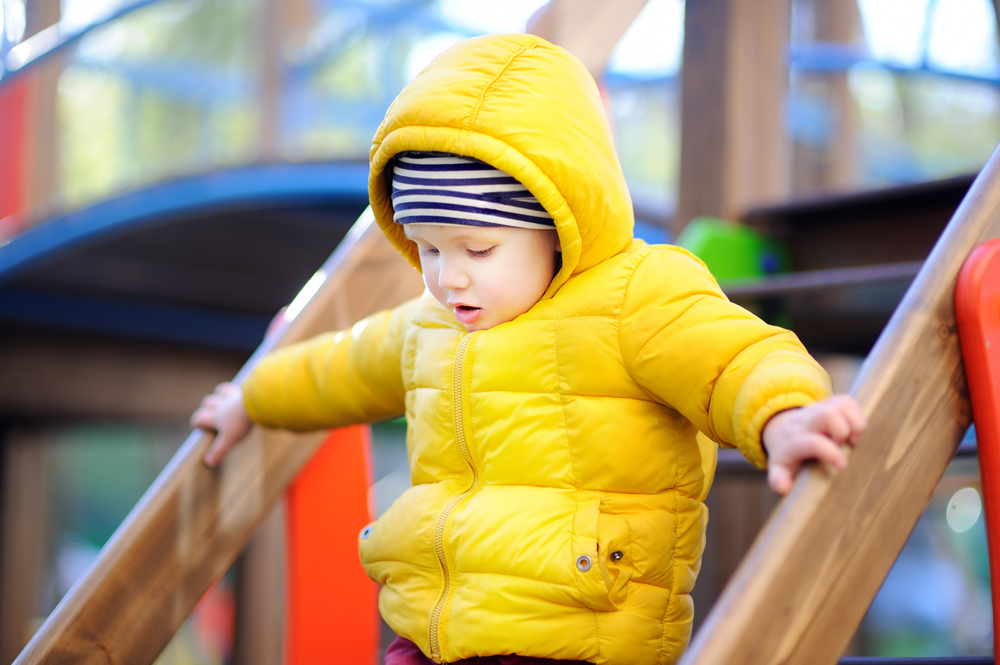 Toddler on outdoor climbing frame