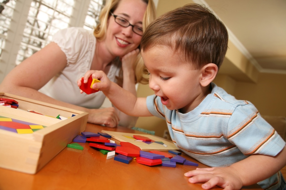 Small boy doing a shapes puzzle