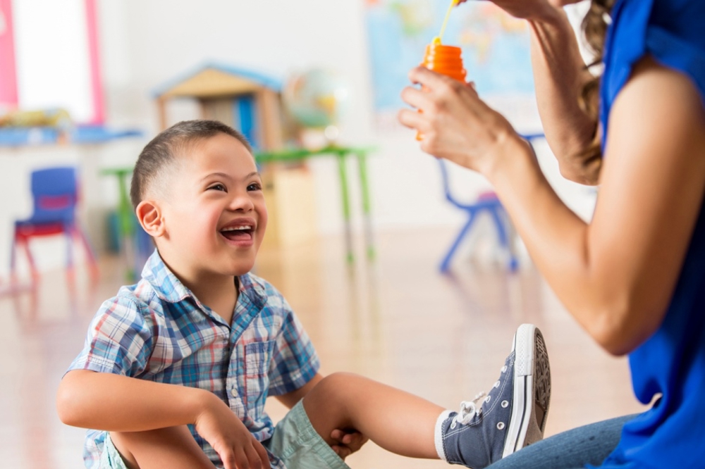 Disabled boy playing with bubbles