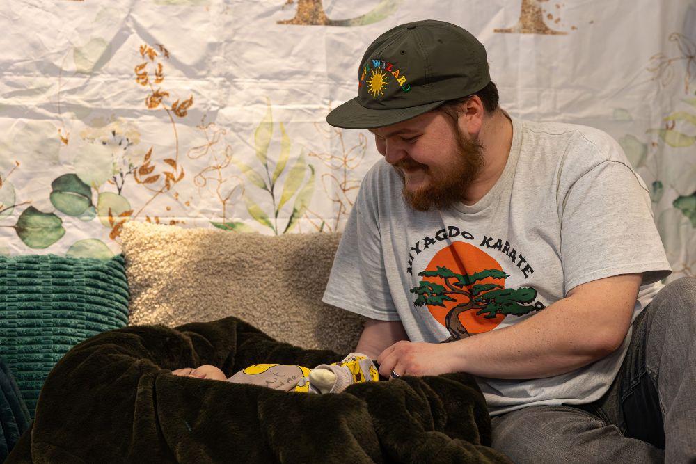 Dad looking at a his baby as part of a photoshoot at the Big Barnsley Baby Shower Dad looking at a his baby as part of a photoshoot at the Big Barnsley Baby Shower