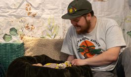 Dad looking at a his baby as part of a photoshoot at the Big Barnsley Baby Shower