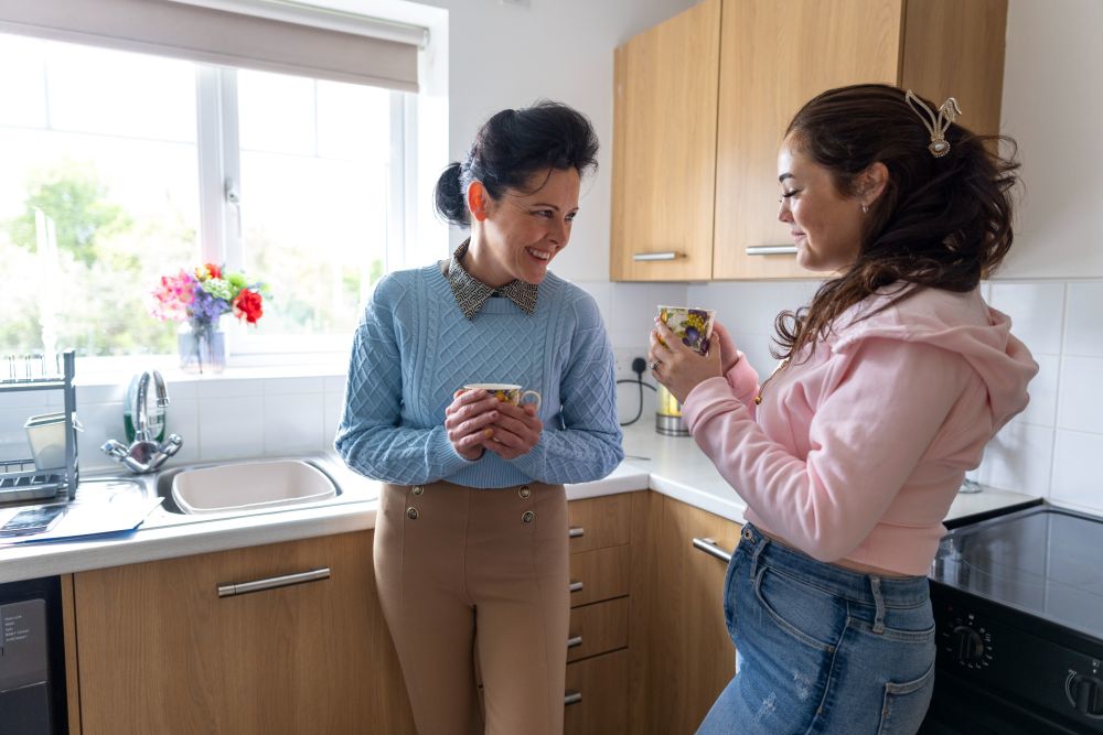 Foster Carer And Teenager Having A Cup Of Tea