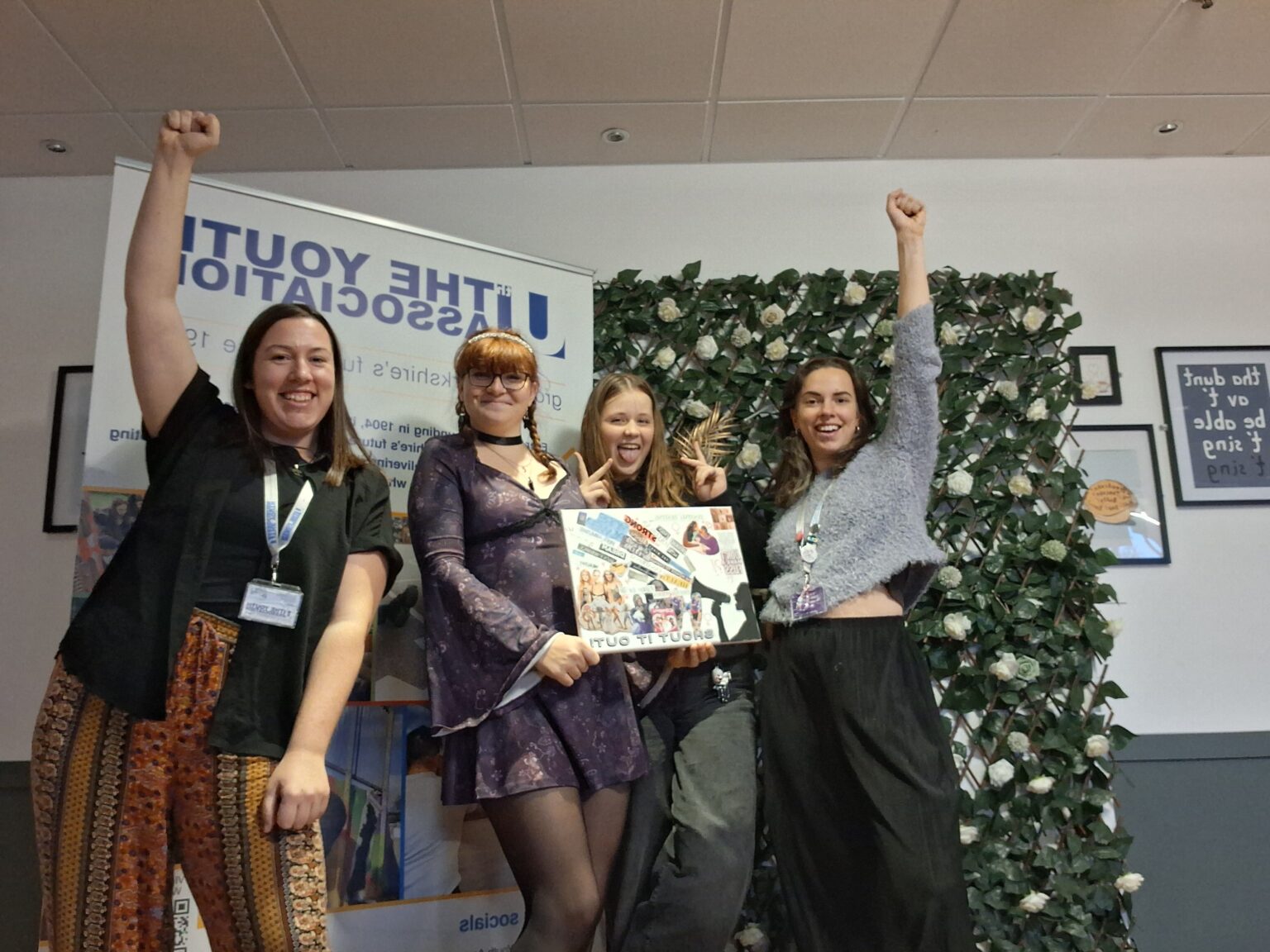 Group of 4 young women holding a sign and celebrating.jpg