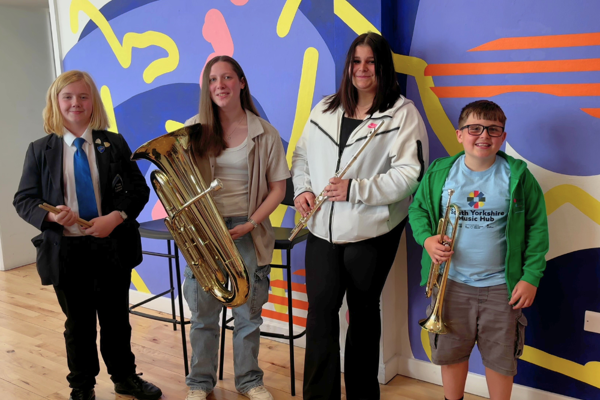 Holly, Harrison, Tia and Quinn from Barnsley Music Service with their musical instruments