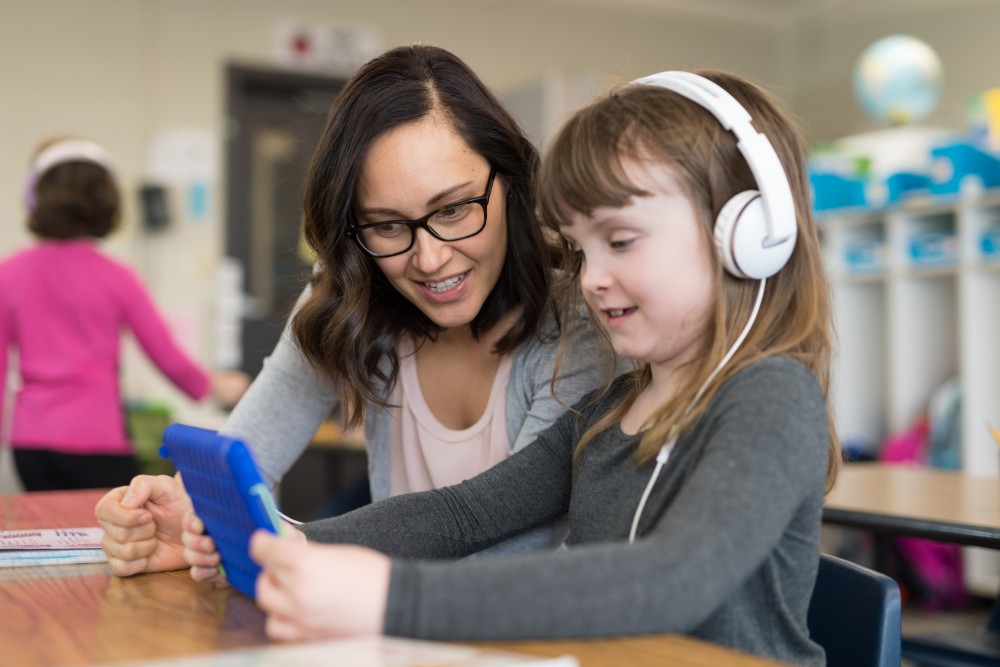 Teacher And Child With Tablet And Headphones
