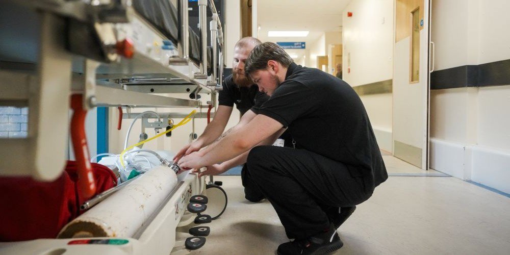 Workers in hospital corridor