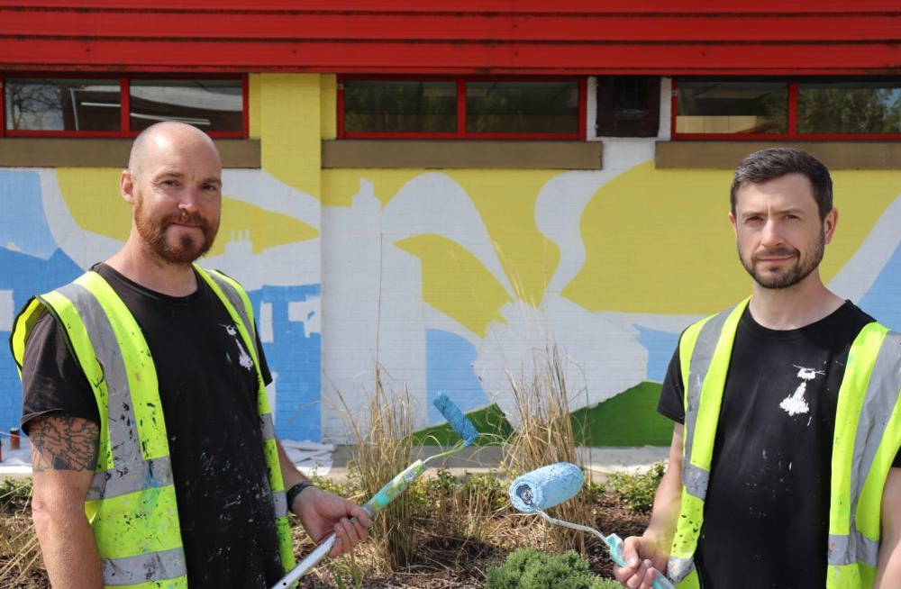 Tom Jackson And Craig Evans Holding Paint Rollers
