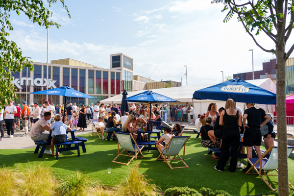 Barnsley Live Event Taking Place In The Town Centre. People Sat Outside Around Dining Tables Enjoying The Summer Weather.