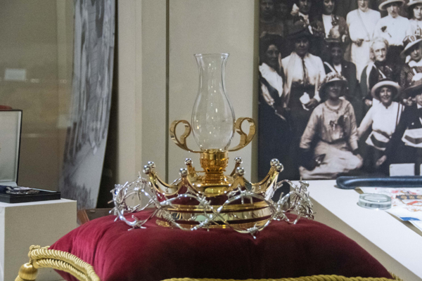 Lamp Of Peace Displayed On A Red Velvet And Gold Cushion