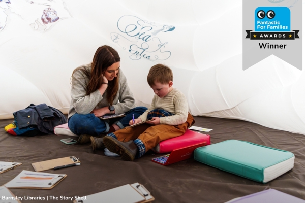 Photo Of Woman And Child Sat In Barnsley Libraries The Story Shell, With Fantastic For Families Awards Winner Graphic