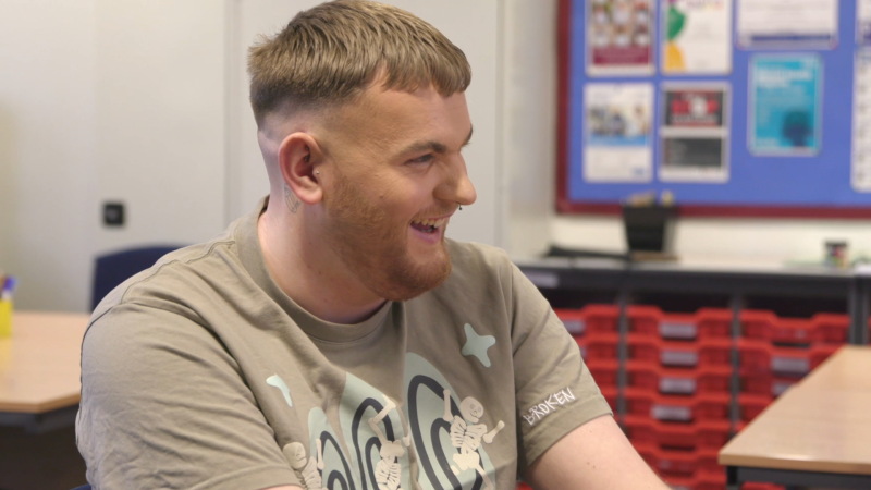 Person in classroom smiling
