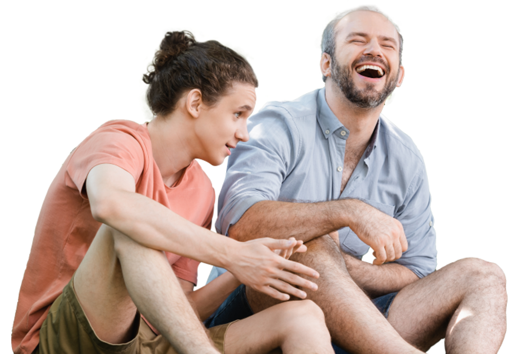 Man and teenage boy sat joking around