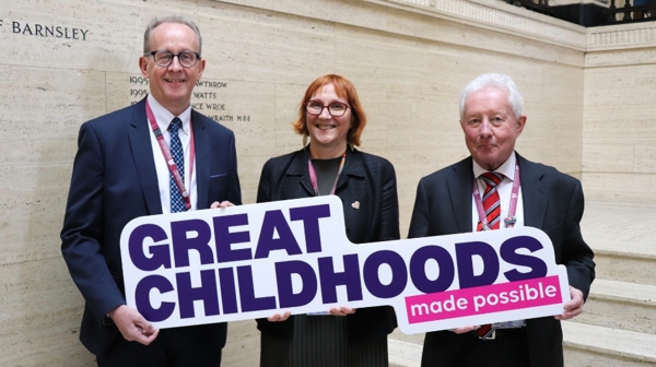 Cllr Sir Steve Houghton CBE, Sarah Norman And Cllr Trevor Cave Holding The Great Childhoods Made Possible Sign
