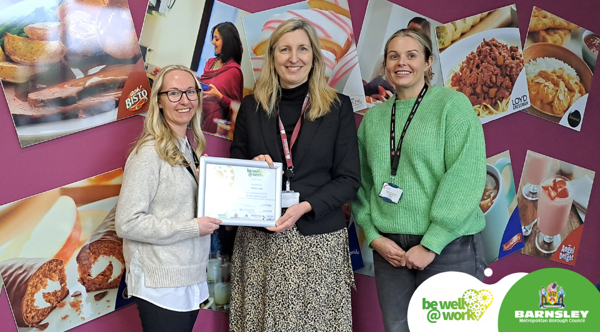 Three People Holding A Certificate