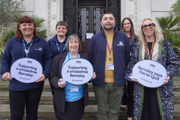 Cllr Cain, Service Director for Health Protection, Carrie Abbot, and smoking service representatives holding 'Yes to Quit' speech bubbles