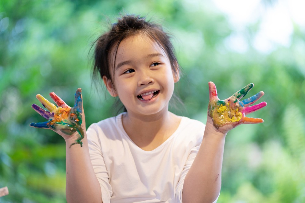 Child with paint on their hands