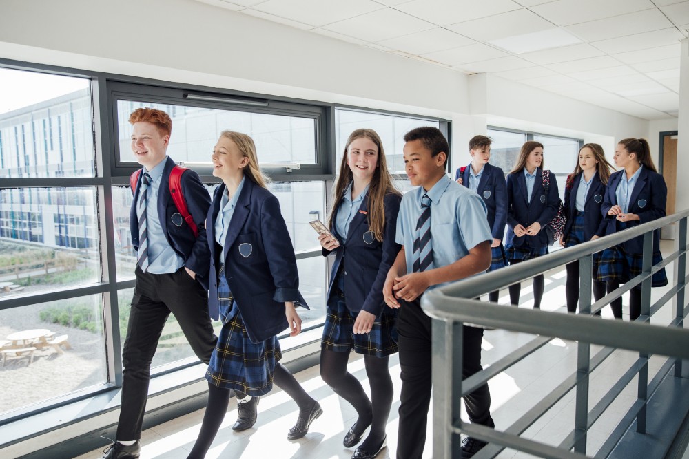 Secondary School Pupils Walking Along Corridor