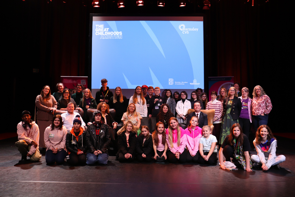 A Group Of People Sat Together On Barnsley Civic Stage Celebrating Their Ambition Arena Pitches