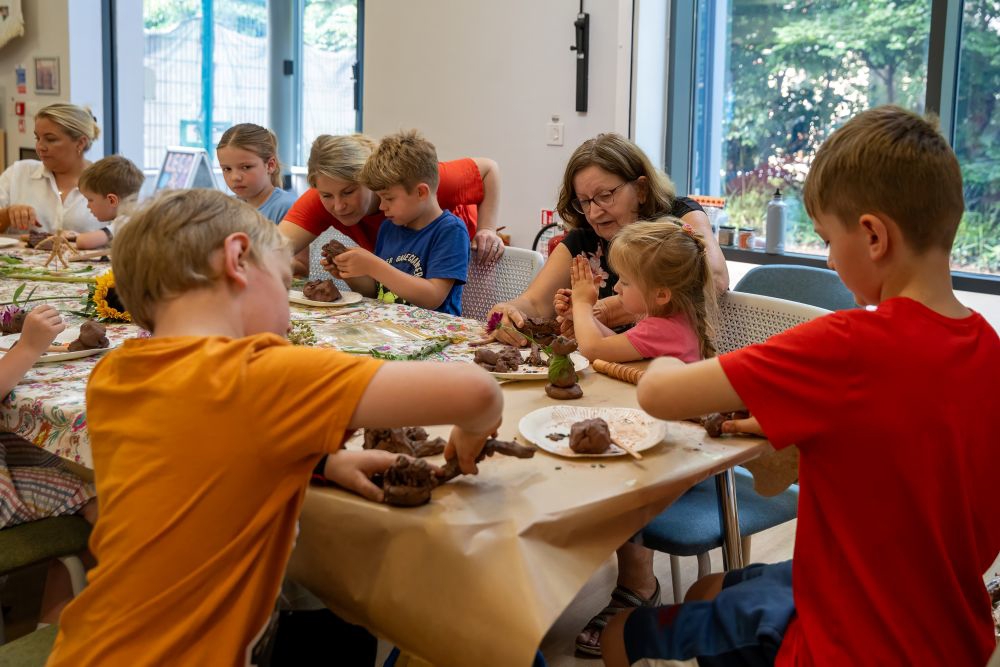 Children Sat At A Table In The Library Doing An Activity