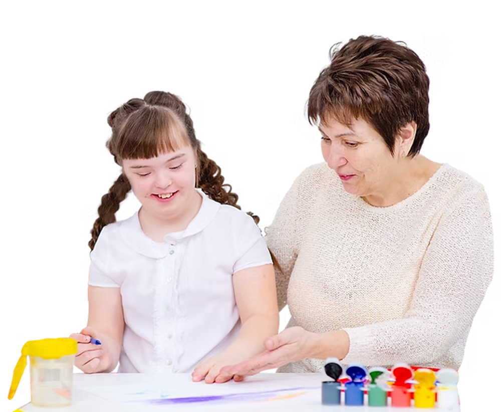 Woman painting with down syndrome child