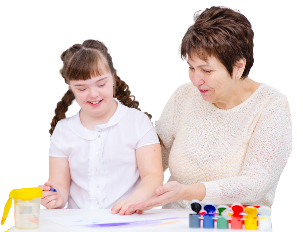 Woman painting with down syndrome child