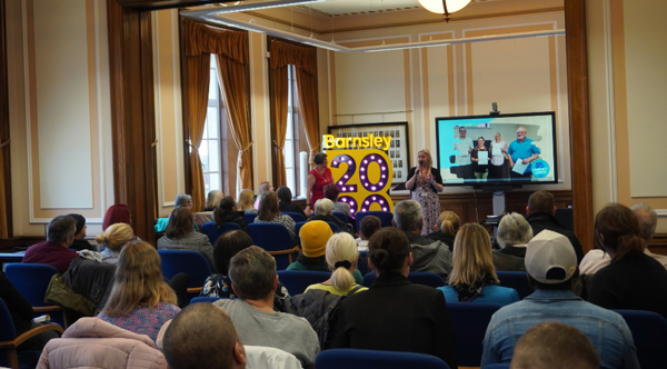 Photo In The Town Hall Showing Learners Listening To A Presentation
