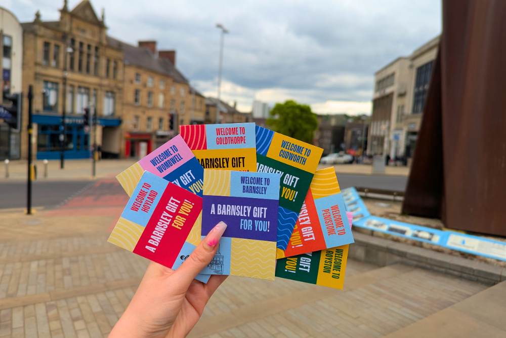 A hand holding Barnsley gift cards in the town centre.png A hand holding Barnsley gift cards in the town centre.png