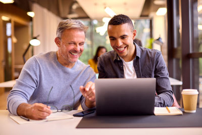 Two people working together with laptop