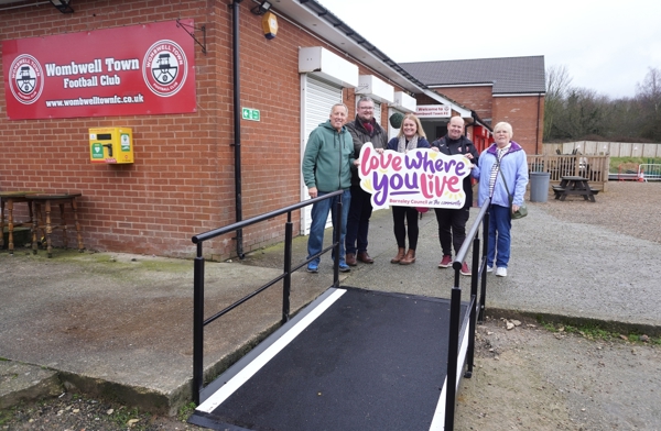 Three men and two women beside a wheelchair ramp at Wombwell Town FC