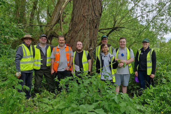 A group photo of Barnsley Museums volunteers doing outdoor maintenance and gardening work.jpg
