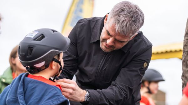 South Yorkshire Mayor Oliver Coppard Helps A Student Put On A Bike Helmet