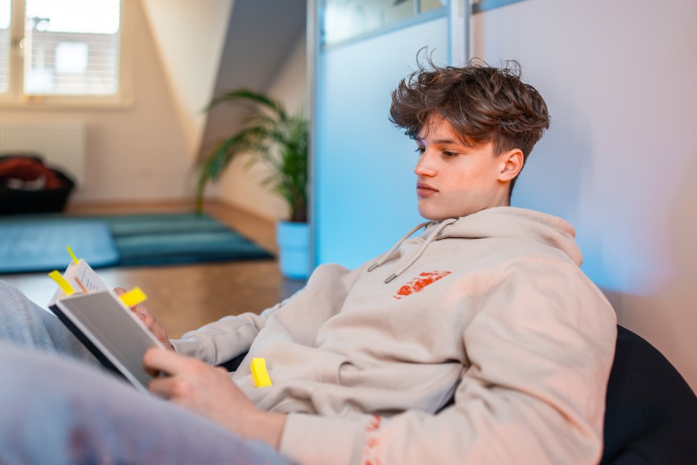 Teenager With Notebook At Home
