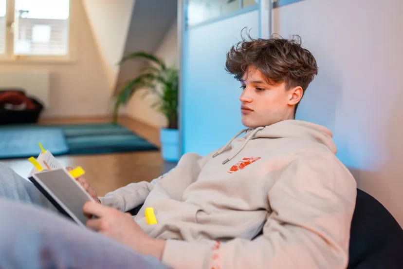 Teenager With Notebook At Home